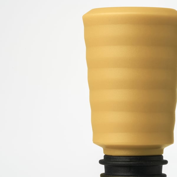Yellow silicone bottle stopper, shown in close-up, demonstrating high-quality, airtight design.