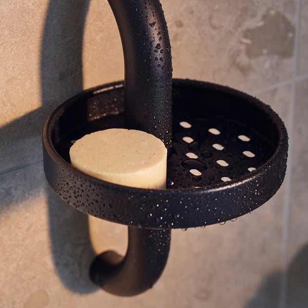 Black shower shelf, dark grey BÄSINGEN series, holds soap, round shape, soft corners, drainage holes.
