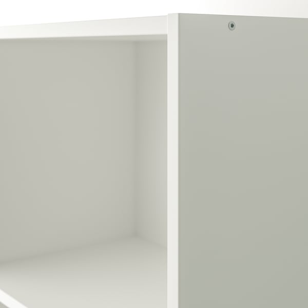 A close-up of a white wooden cabinet with smooth, clean surfaces and a tight-fitting door, showing high-quality craftsmanship.