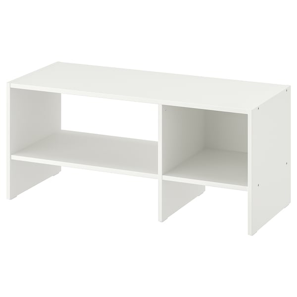A BAGGEBO tv bench in white. It has a minimalist design with open storage. Crafted from particleboard and fiberboard, it two open shelves for storage.