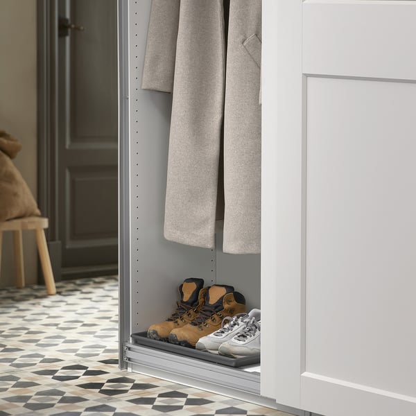 Shoe mat under coat rack, stores two pairs of shoes, protects floor from dirt, fits narrow spaces.