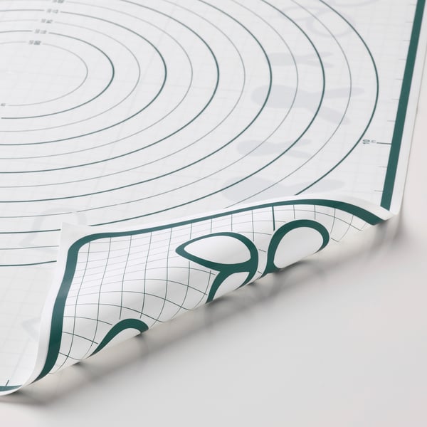 Large baking mat with green edge and grid patterns. Shows both circular and square designs for precise baking.