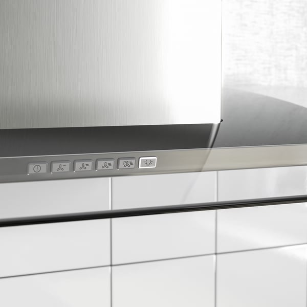 Modern stainless steel range hood featuring control panel, led lights, and sleek glass edge.