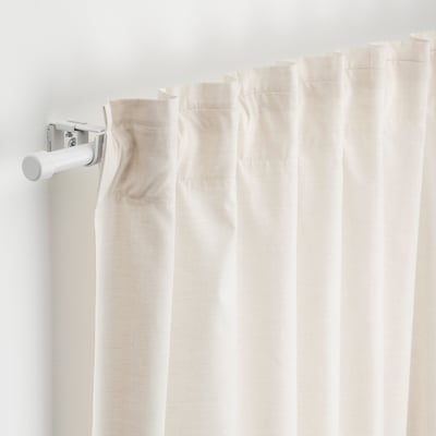 White curtain rod set with multiple brackets and connectors, mounted on wall, ready for curtain.