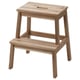 A wooden step stool named BEKVÄM made of acacia wood, designed for reaching high places.