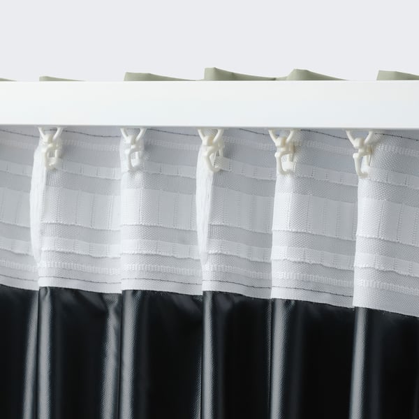 White curtains with hooks hanging, featuring textured fabric and lining, designed for light blockage and easy customization.