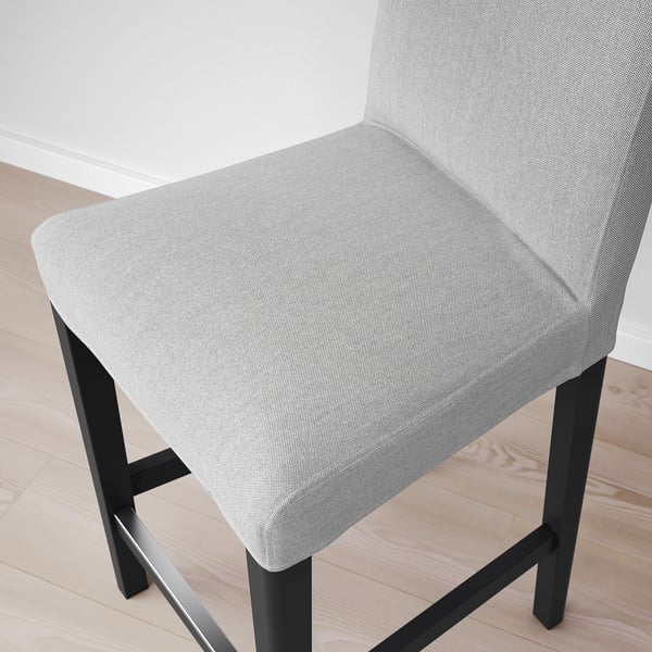 Modern stool with sleek black legs, padded in soft grey, offering cushioned comfort.