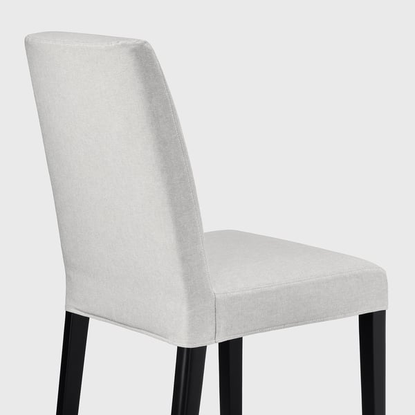Modern chair with light fabric, black legs, padded back & seat.
