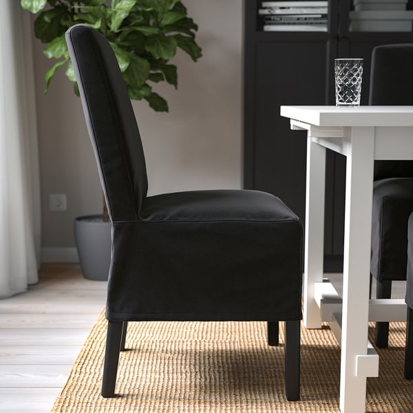 Modern upholstered black dining chair with high back, comfortable seat, and solid wood legs.