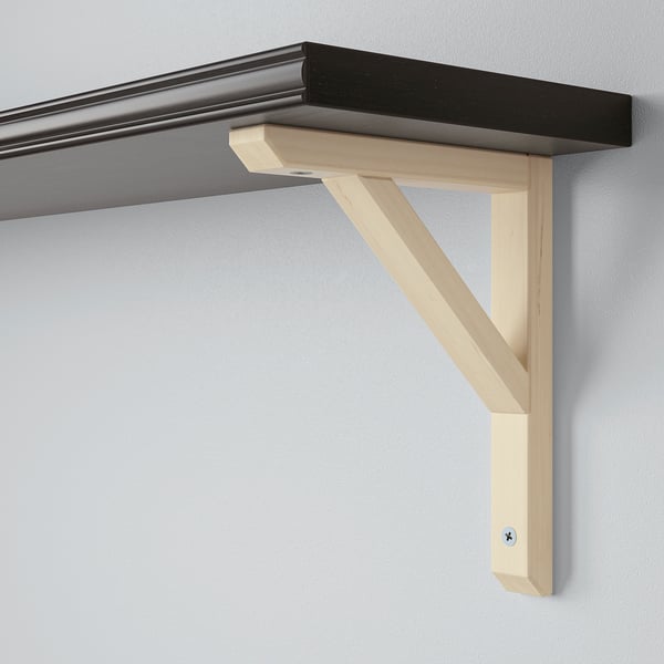 Wall-mounted shelf with light wood bracket, thin black shelf, securely fixed to a smooth wall.