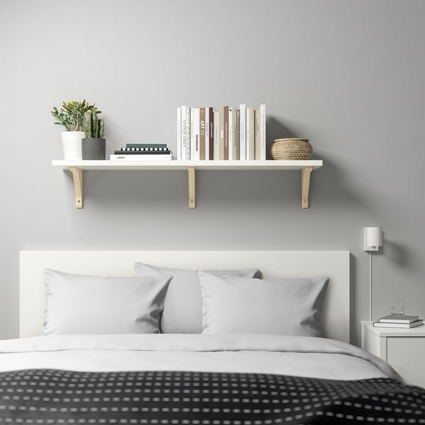 Bedroom with BERGSHULT shelf, plant, books, basket, bed, lamp