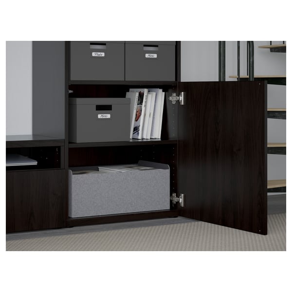 Wooden cabinet with grey storage boxes. The door has a push-open function.