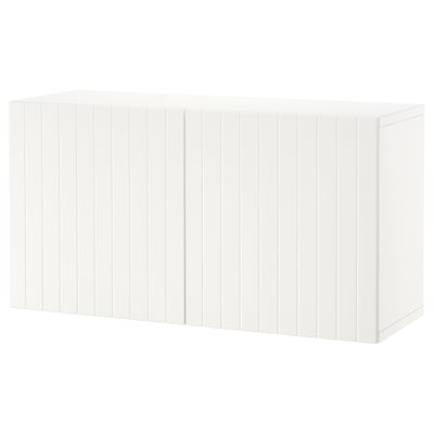 A white BESTÅ storage drawer unit. It is simple, rectangular, and wooden with a grooved design. Perfect for organizing home items.