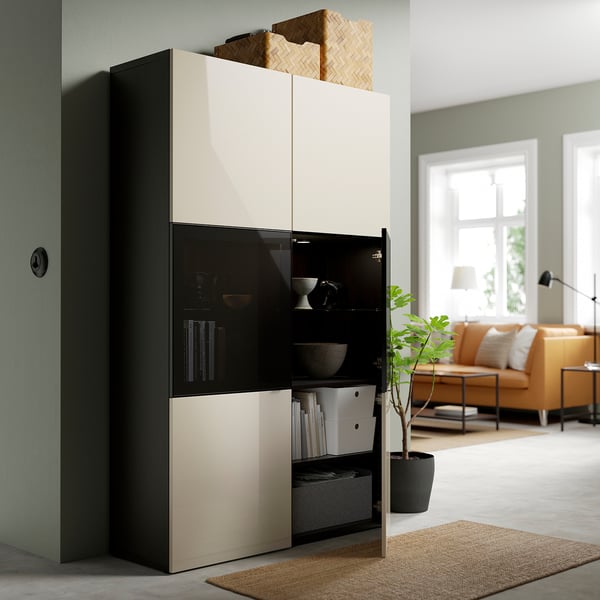Modern cabinet with open glass doors showing decorative items and books, featuring adjustable shelves and soft-closing hinges.