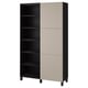 A black and beige BESTÅ storage cabinet with adjustable shelves. It a modern design with a mix of open and closed storage.