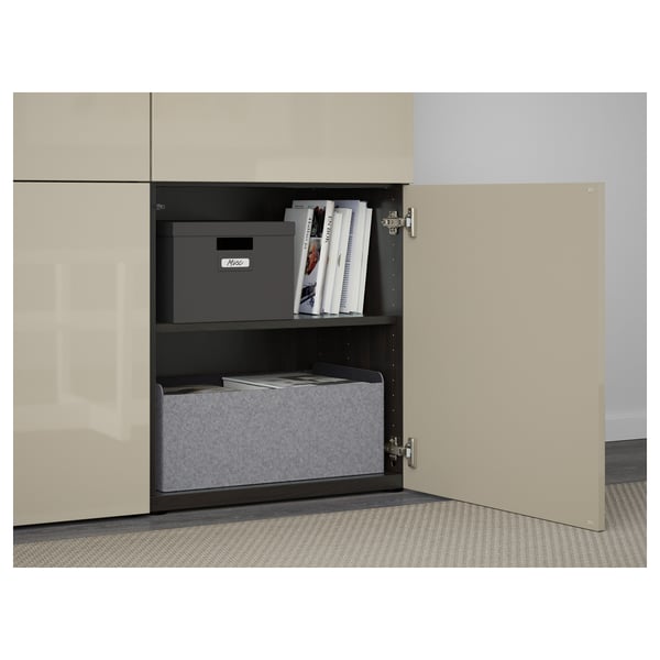 Open tan cabinet reveals storage boxes and magazines.