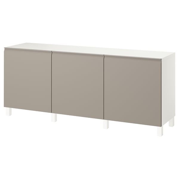 An ikea BESTÅ sideboard in beige with white legs. This storage unit has three wide sections with minimalist handles and a sleek, rectangular design.