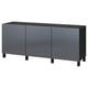 A grey IKEA BESTÅ sideboard with 3 doors, providing ample storage. The modern design a sleek, glossy finish and black legs.