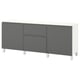 An ikea BESTÅ sideboard in white and dark gray with four doors and two drawers.