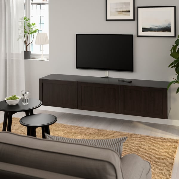 Modern living room with BESTÅ tv bench, flat screen, grey sofa, and woven rug.