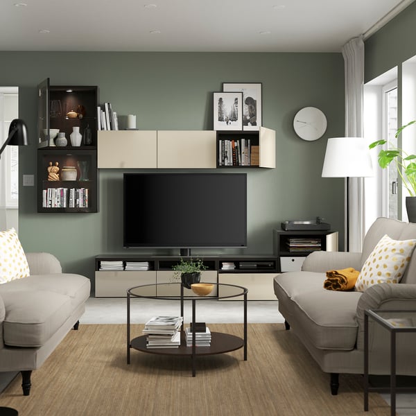 Green living room with BESTÅ tv unit and wall cabinets.