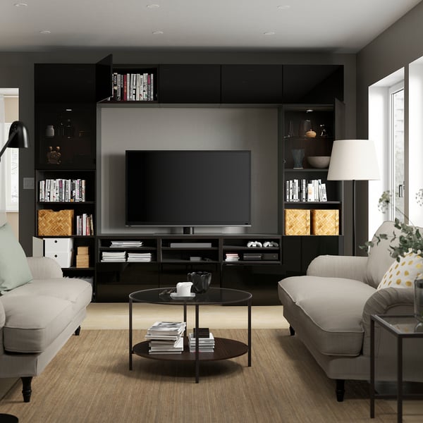Modern living room with BESTÅ tv unit, two sofas, and a coffee table. Adjustable shelves and storage.