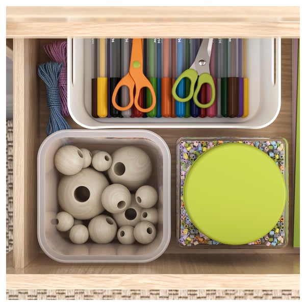 Organised storage shelf with crafts: coloured pens, scissors, wooden beads, and a round container with beads.