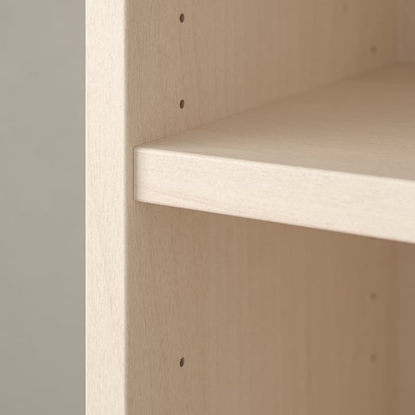 A light-colored wooden shelf, part of a bookcase, showcasing a smooth, even finish and high-quality craftsmanship.