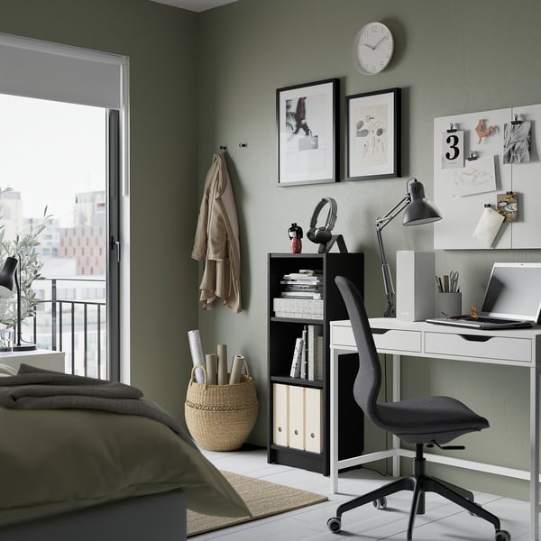 Home office with BILLY bookcase, white desk, grey chair, large window, green wall.