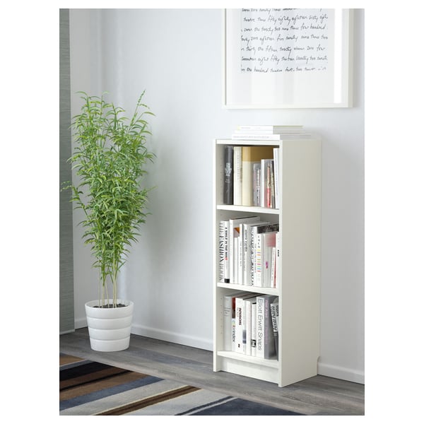 White BILLY bookshelf with books and plant.