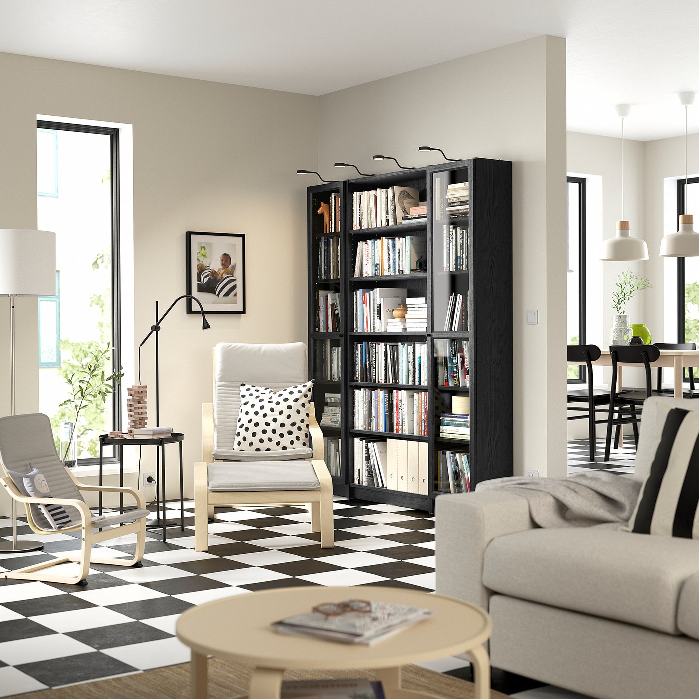 Modern living room with BILLY black bookcase, white furniture, chequered floor, large window, and pendant lights.