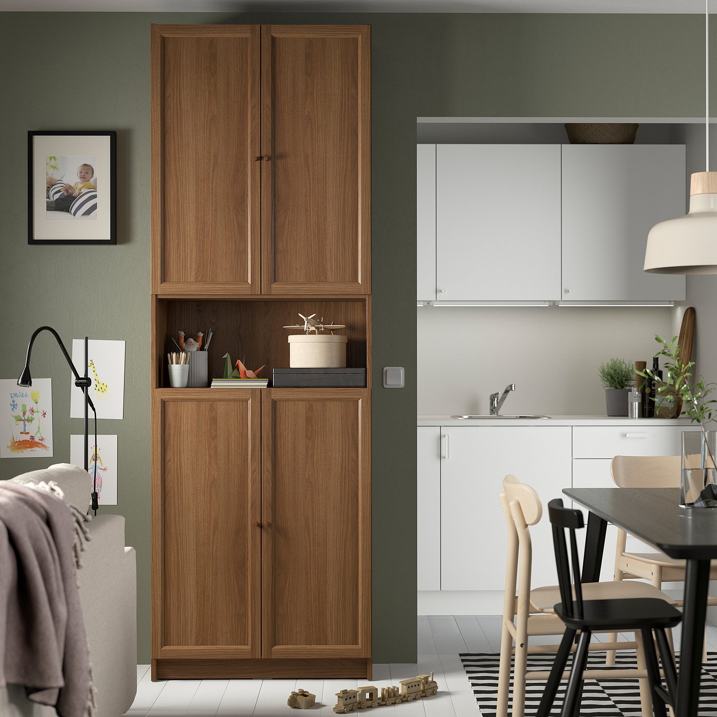 Cosy kitchen with BILLY bookcase, dining area, toys, and green wall.