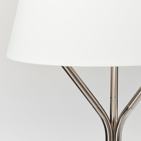 Distortions-free a modern lamp with a white shade and metallic base.