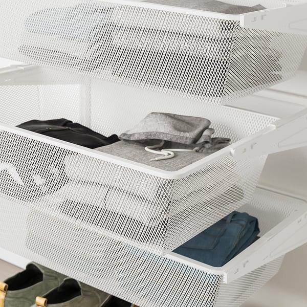 White BOAXEL mesh drawers holding folded clothes. Top drawer empty, middle and bottom drawers filled with neatly folded garments.