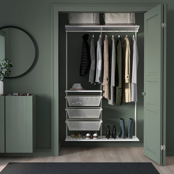 Closed green door of a wardrobe with hangers and white mesh baskets inside.