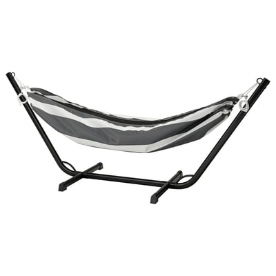 The BOCKÖN hammock, black & white striped, hangs on a metallic frame. Perfect for relaxing outdoors.