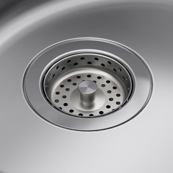 Stainless steel sink strainer with perforated design and central plug, showcasing quality and hygiene.
