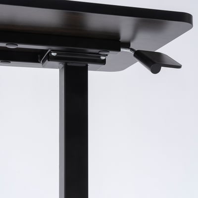 Close-up of a black adjustable table base with metal legs and mechanisms, showcasing sturdy construction and smooth finish.