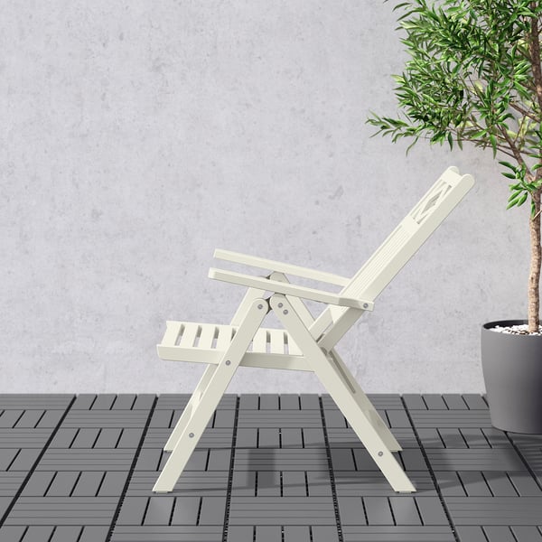 Foldable outdoor chair with adjustable backrest, shown in white, placed on tiled floor.
