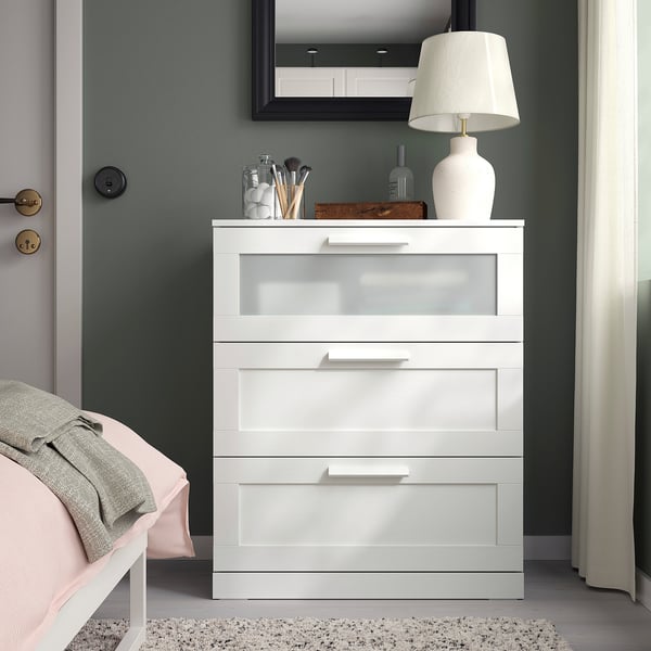 BRIMNES white chest with glass drawer, mirror, lamp & bed in room.