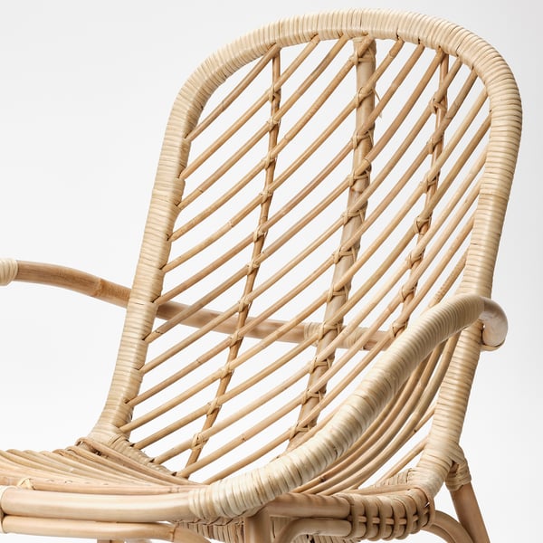 Hand-woven rattan armchair, showcasing intricate craftsmanship. Lightweight and sturdy with earthy tones.