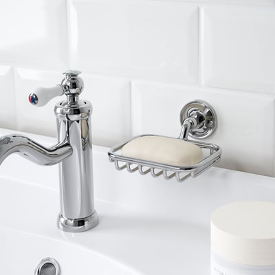 Chrome soap dish holds soap, mounts on wall, keeps it tidy and accessible.