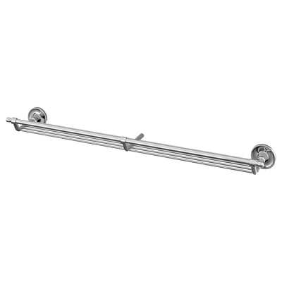 Chrome bathroom shelf, classic design, holds soaps & creams near sink.