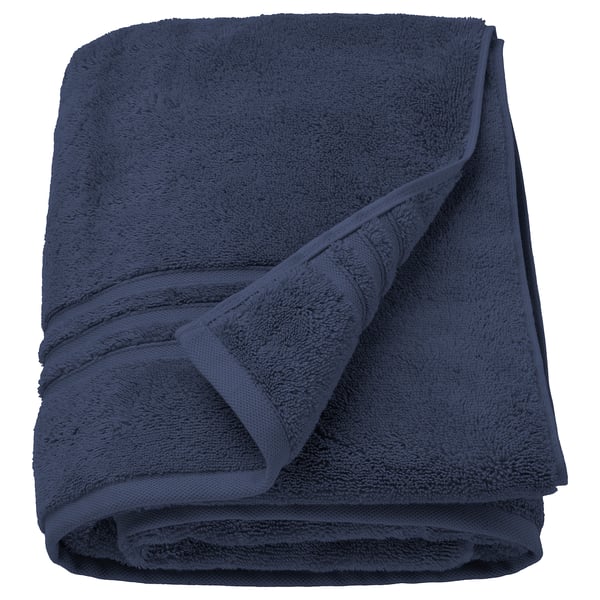 Dark blue BROKGLIM towels, folded neatly, with a woven border.