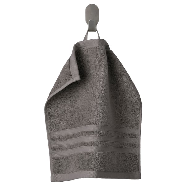 Grey BROKGLIM organic cotton towel on hook with woven border.
