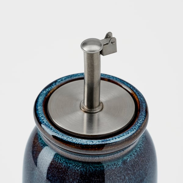 Small stoneware jar with metal spout and lid, blue glaze, quality seal, functional and decorative.