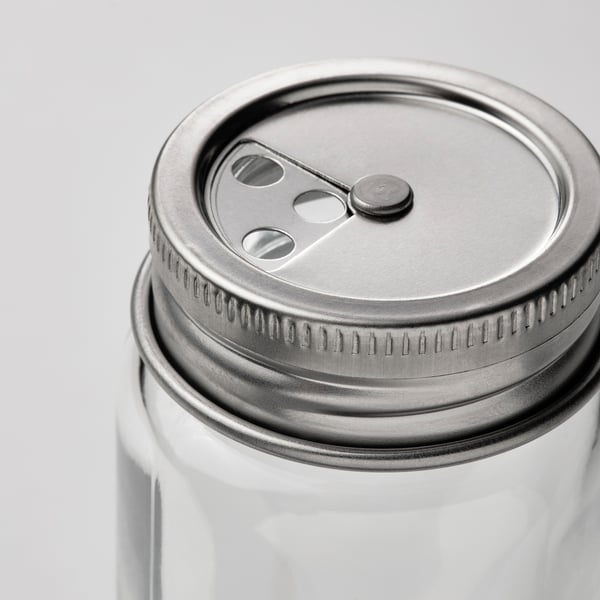 Glass jar with stainless steel lid and air holes for freshness.