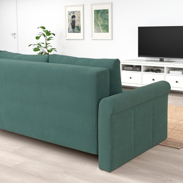 Green DÅNHULT sofa bed with tv, converts into bed with pocket springs and storage.