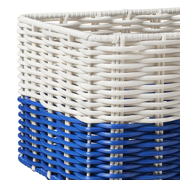 A white and blue wicker basket, expertly handwoven, with intricate weaving patterns visible.