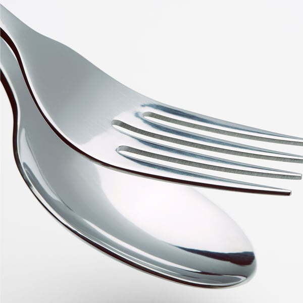 Close-up of polished, stainless steel fork, reflecting light, showcasing its smooth, durable surface.